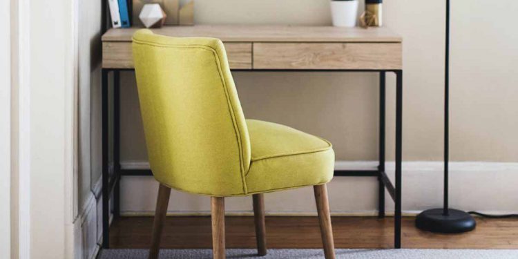 Yellow chair and desk in corner of room