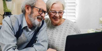 Mature couple looking at laptop