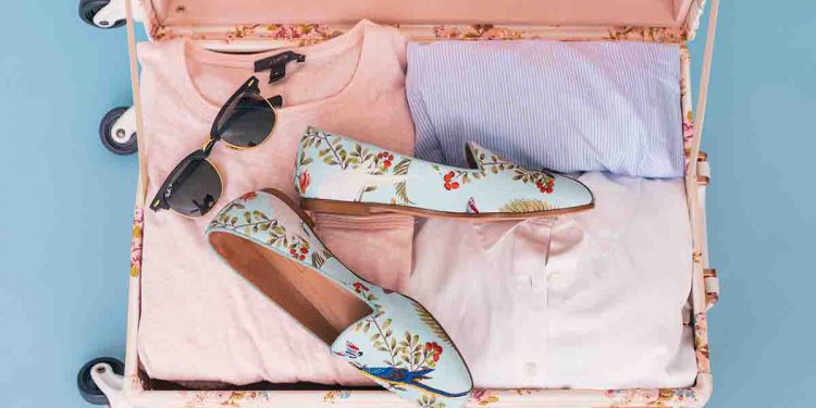 Suitcase with pink and purple pastel clothing