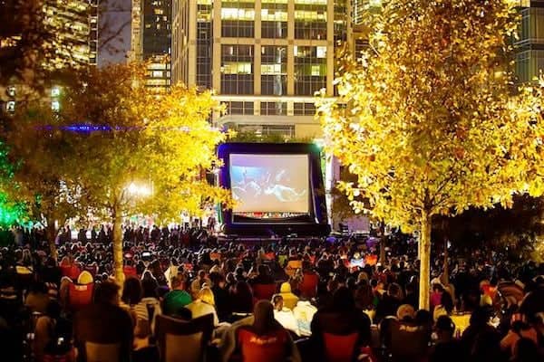 people watching an outdoor movie at Discovery Green in Houston