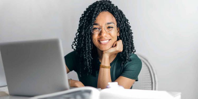 Woman smiling at laptop