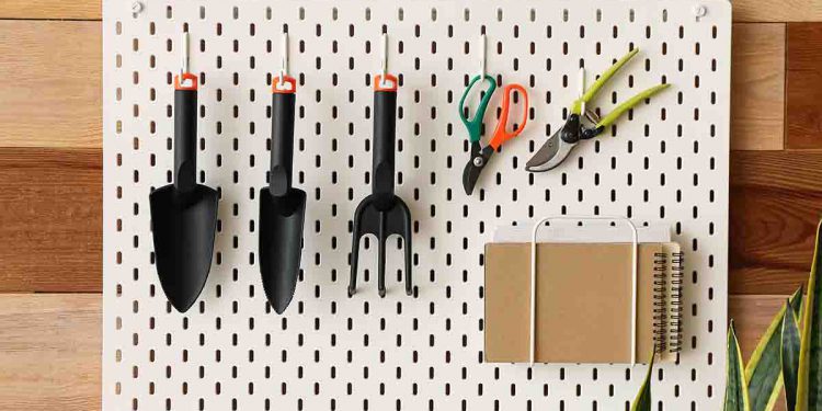 Gardening tools hung on a pegboard