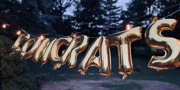 Congrats written in golden balloons