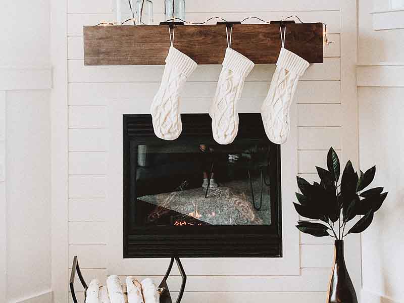 White wall with fireplace and stockings
