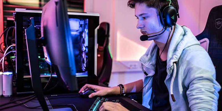 Young man playing a video game with a headset on