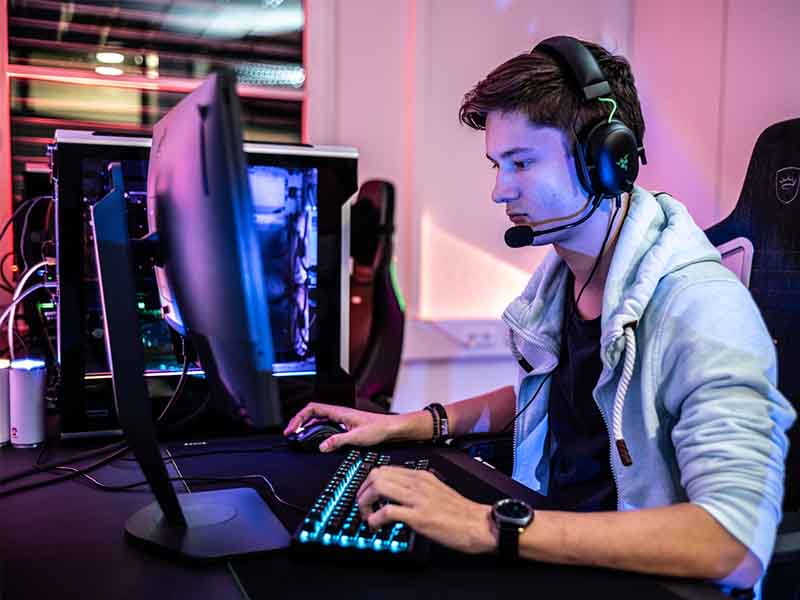 Young man playing a video game with a headset on