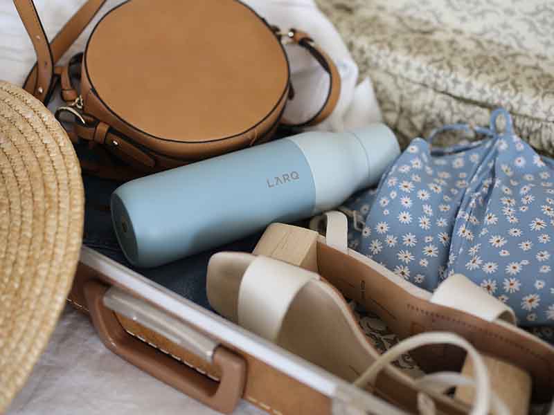 Small carry-on suitcase with items inside