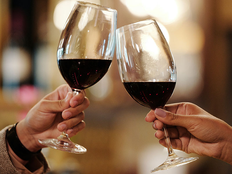 Two people with wine glasses.