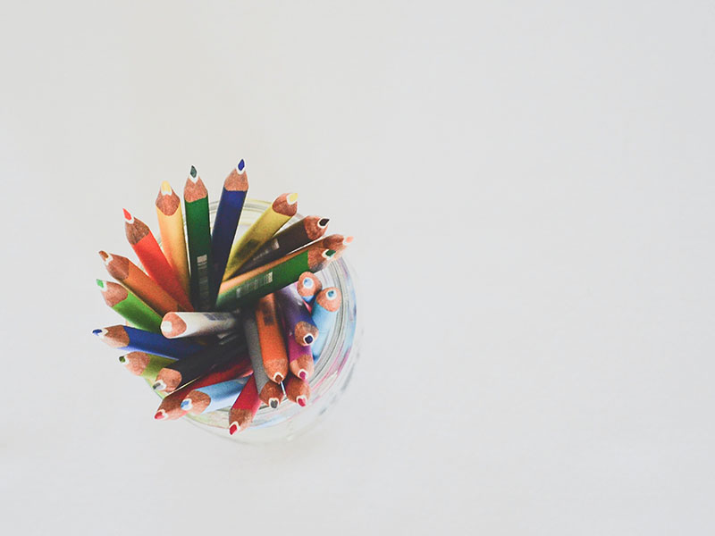Colored pencils in a glass jar.