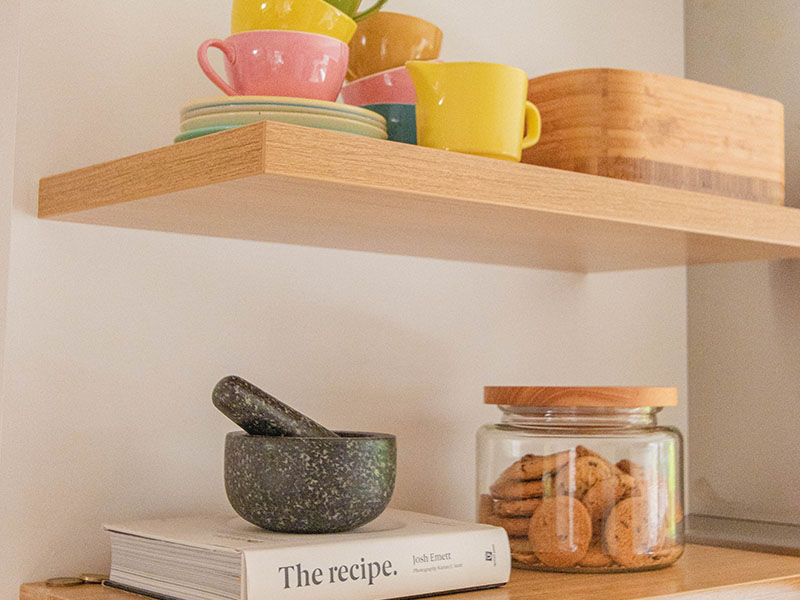Floating wooden shelves with books and items on top