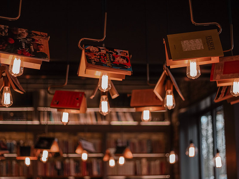 Lights and books hanging from the ceiling