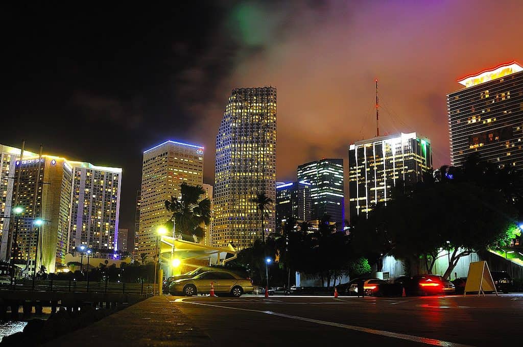 downtown miami at night with buildings lit up