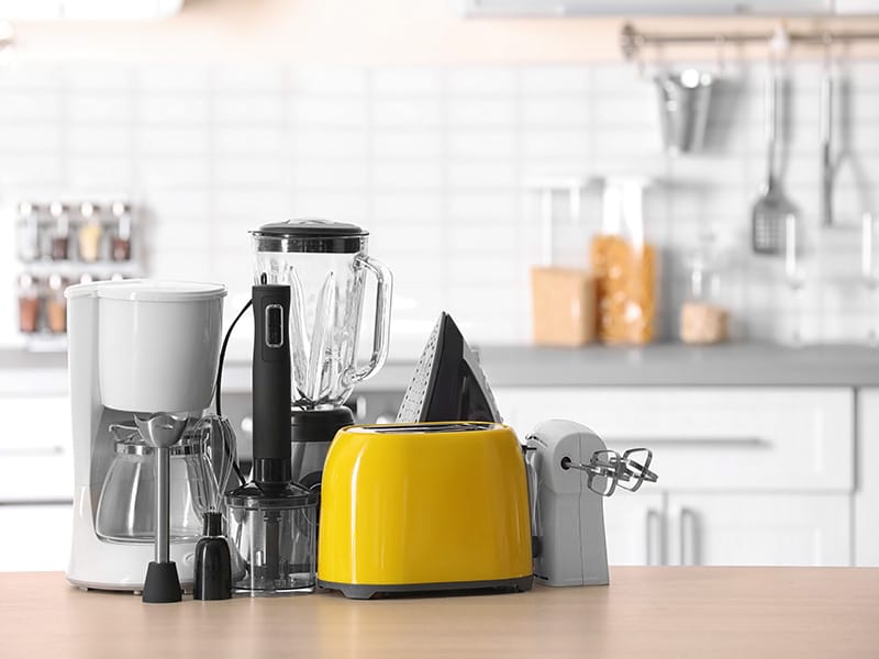 yellow toaster, white coffee maker, white mixer and blender on kitchen counter,
