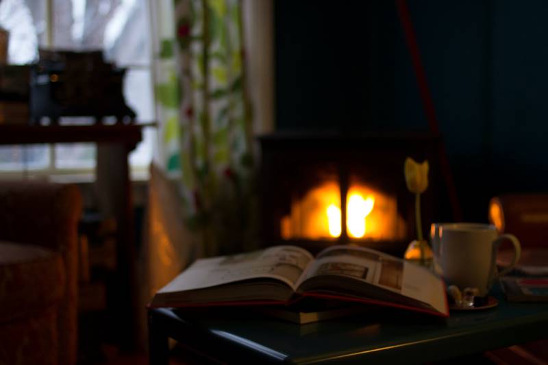 hygge open book in front of fireplace