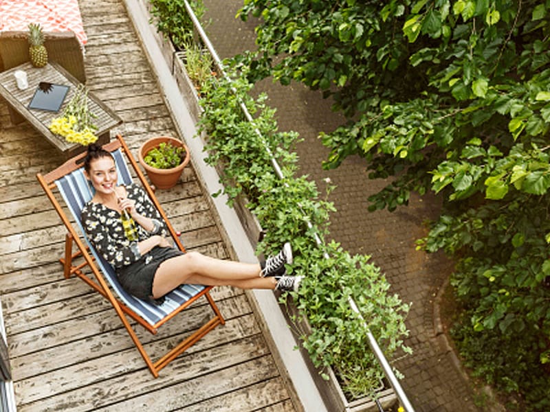 woman with feet up lounging on back deck