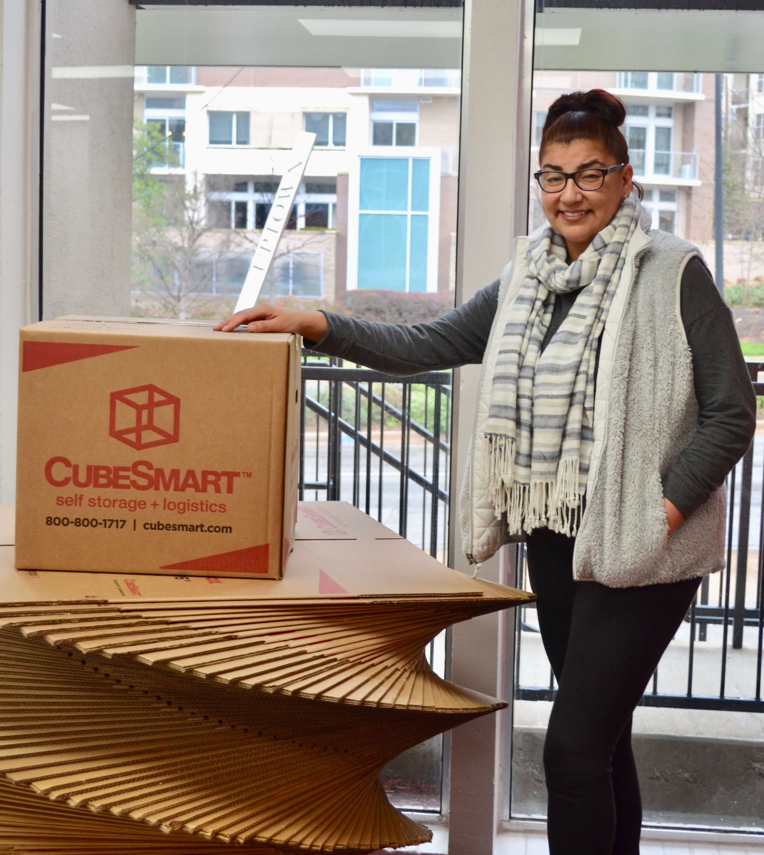 Veronica S. standing next to CubeSmart boxes