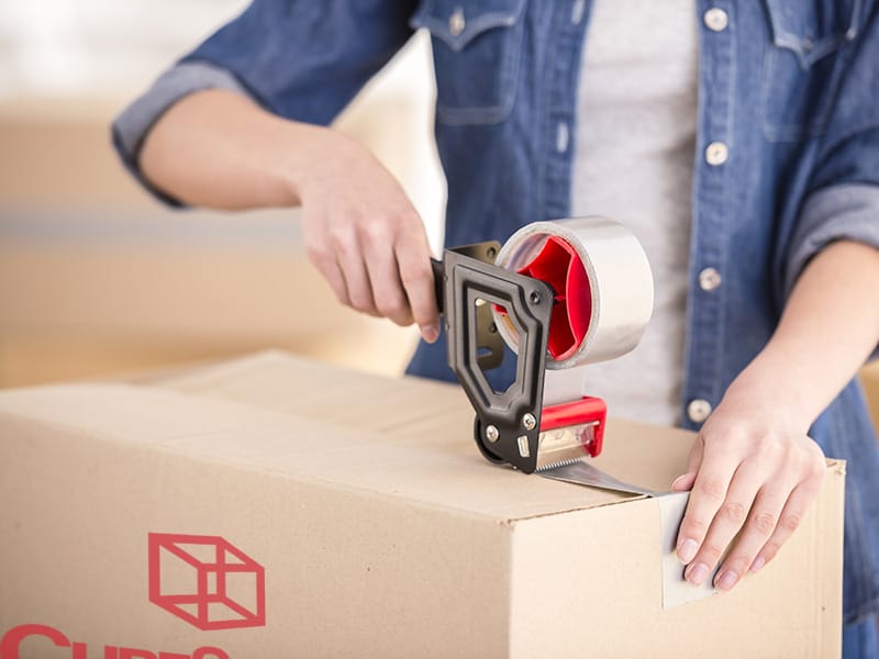 taping a moving box closed