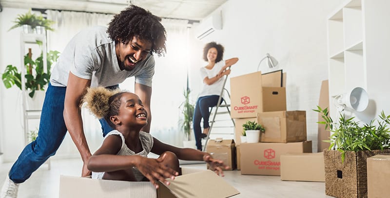black family packing boxes having fun