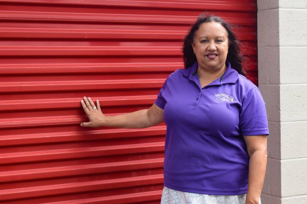 Rev Vanessa Tinsley standing next to her storage unit