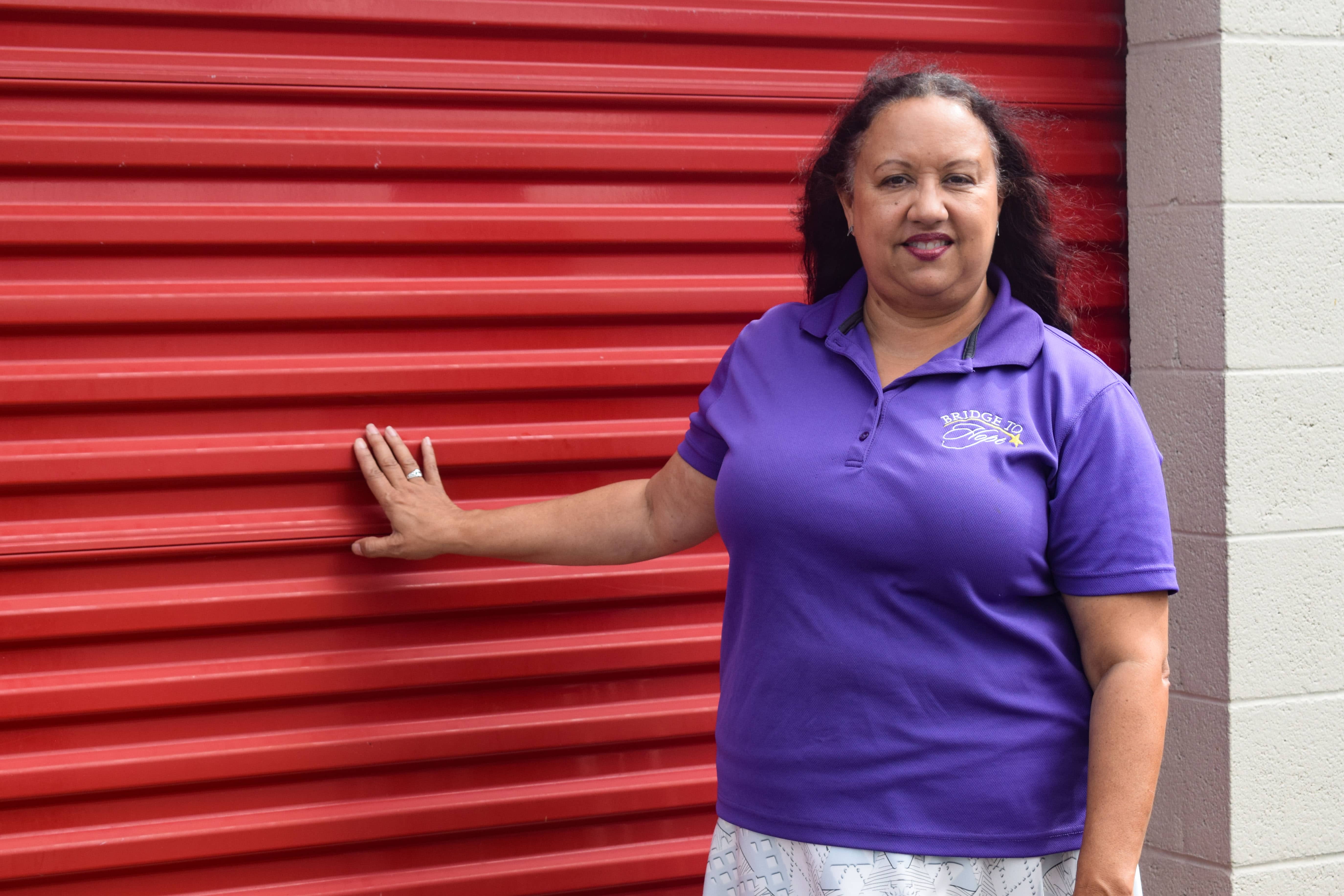 Rev Vanessa Tinsley standing next to her storage unit