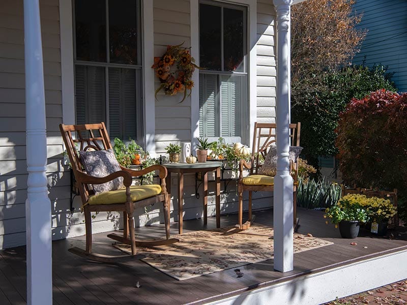 front porch with two rocking chairs with pillows