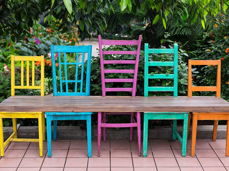 colorful wood dining chairs turned into a sitting bench