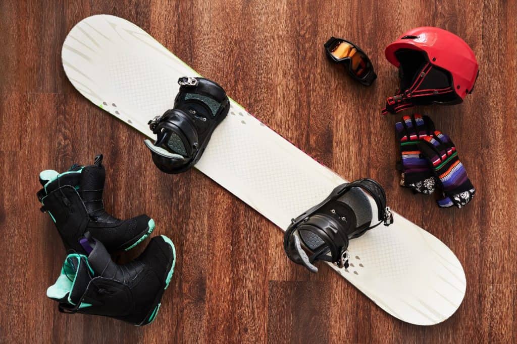 snowboard gear on a wooden floor