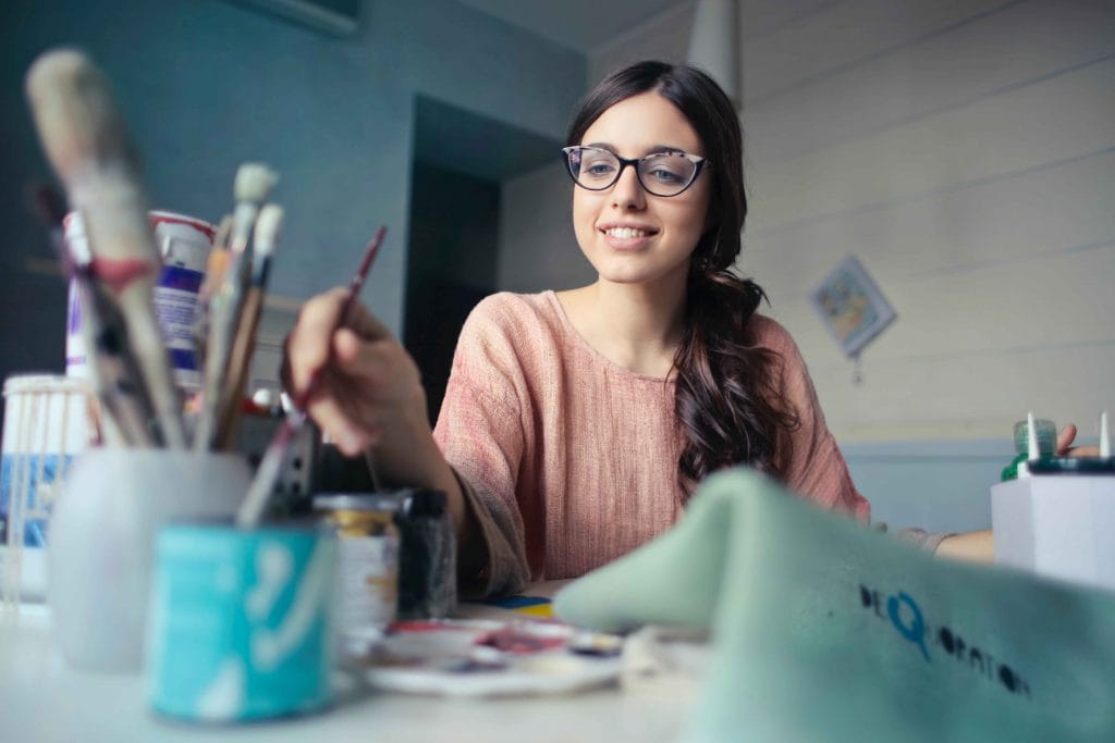 woman with paint brushes