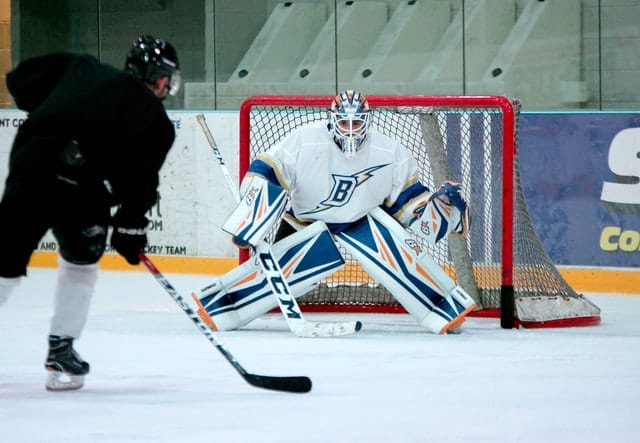 hockey goalie defending the goal