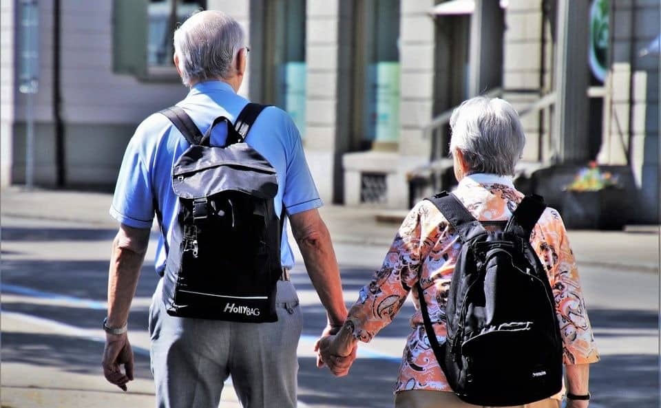 Couple walking around NYC with all-weather bags
