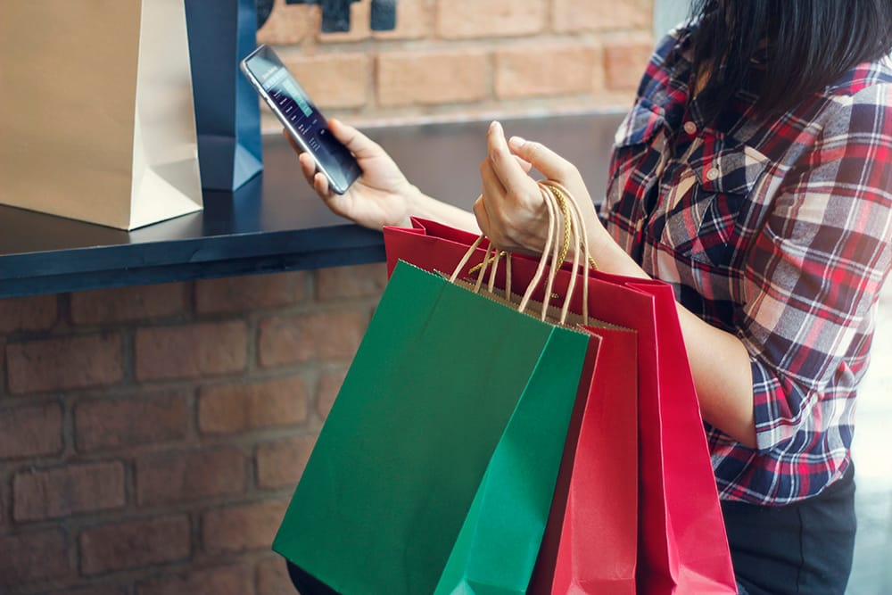 woman using christmas shopping app
