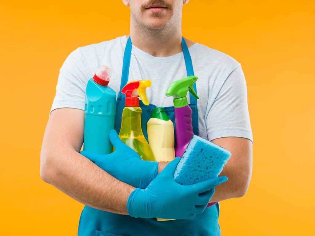 man holding cleaning products