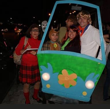 Group of adults dressed in costumes at the Montrose Pub Crawl in Houston, Texas