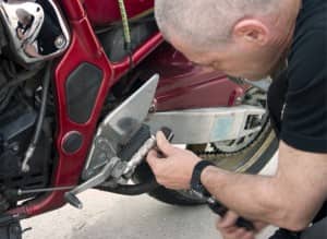 man fixing a motorcycle