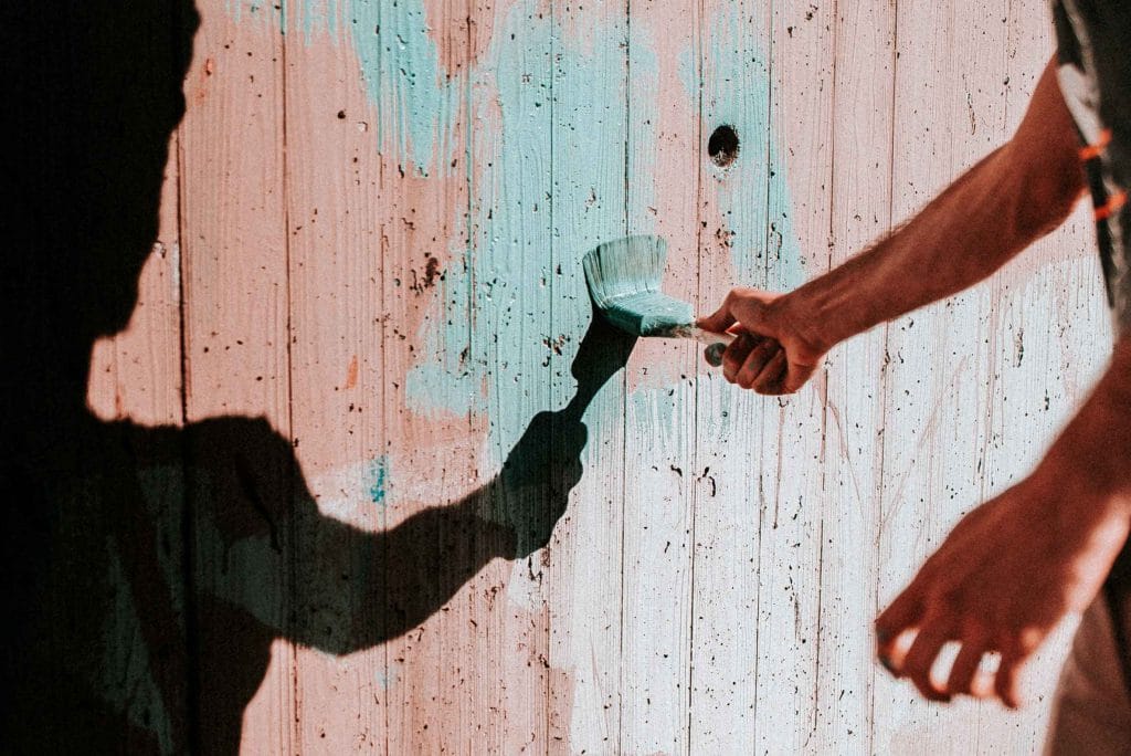 painting a fence light blue