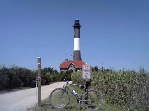 a bike parked outside of a lighthouse