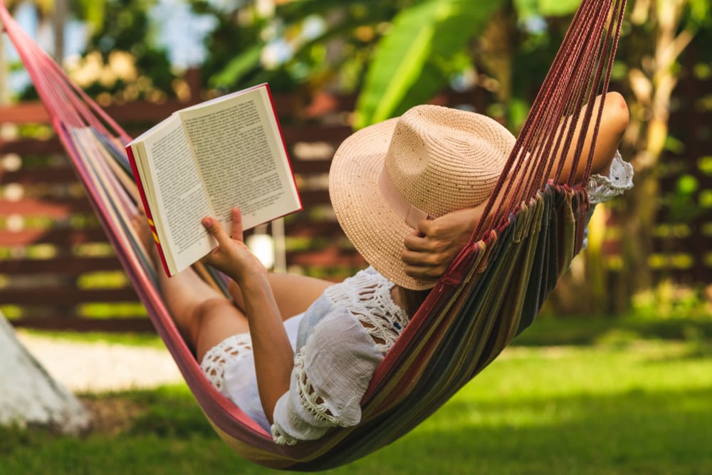 woman in hammock reading a book