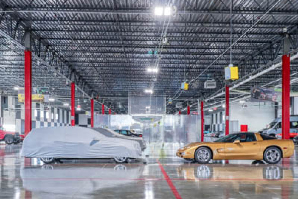 Parked cars inside a well-lit, climate-controlled parking garage.